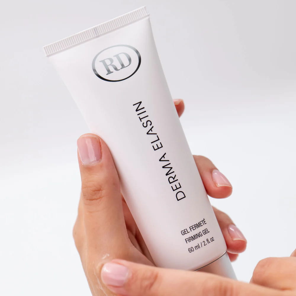 Hands holding a tube of RD Cosmetic Derma Elastin Firming Gel 60ml (2 fl.oz.).